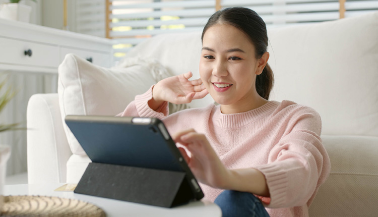 Woman smiling at laptop